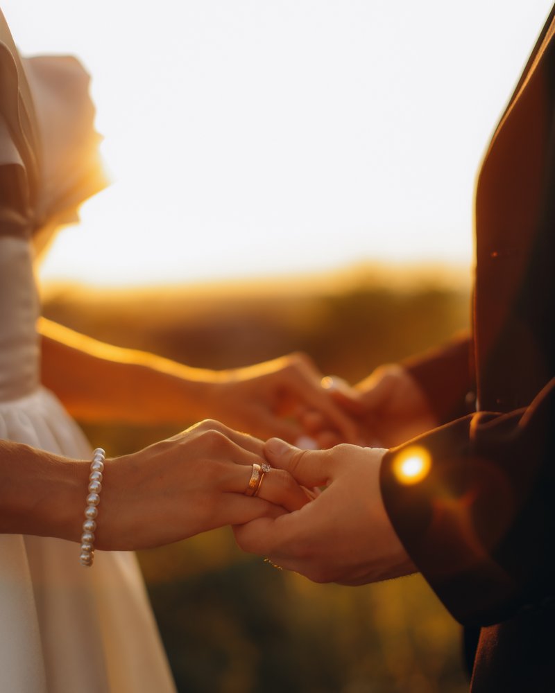 A couple holding hands on their wedding day
